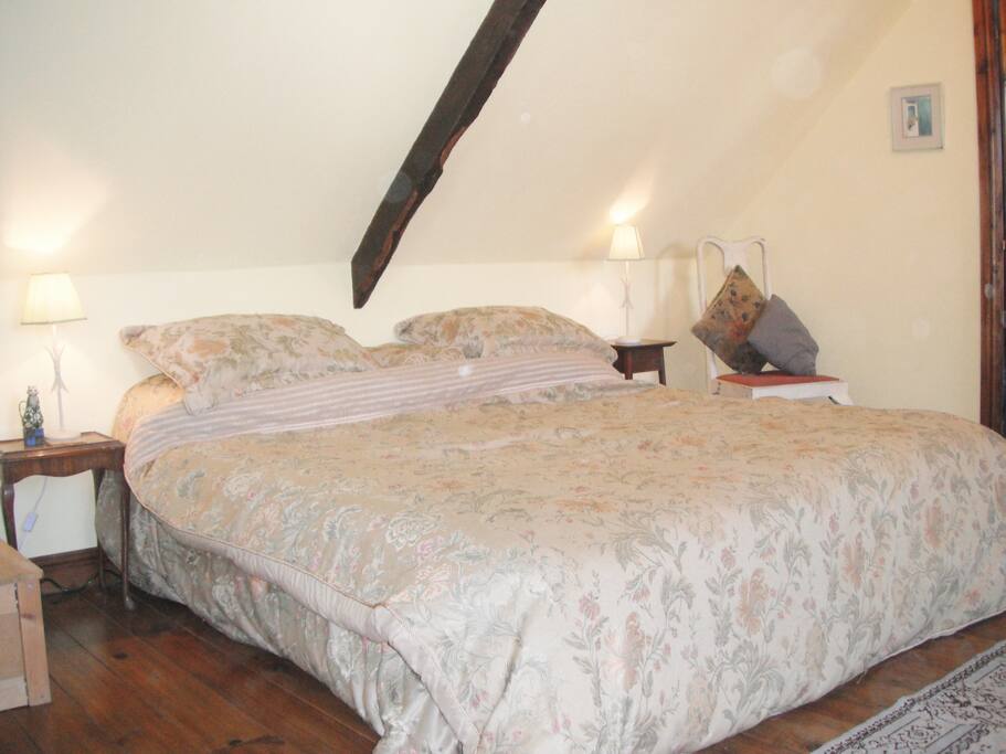 The bedroom is on the first floor - accessed via a traditional wooden staircase