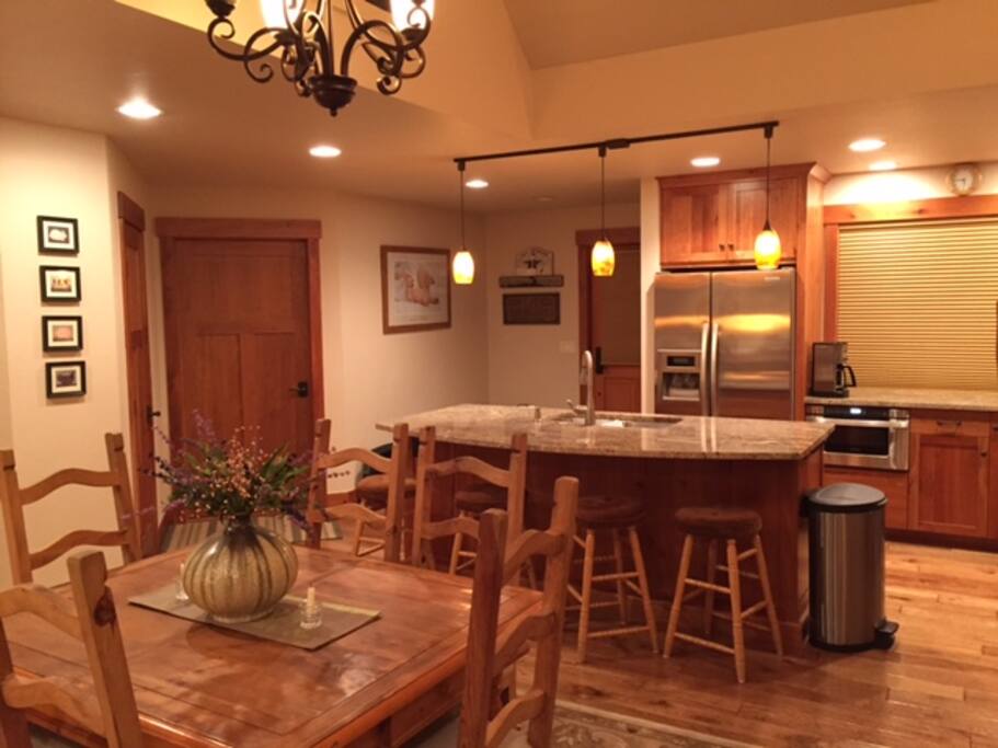 Kitchen, gas stove, Bosch dish washer, granite counters, island with lots of electric outlets, dining area. Hunter Douglas blinds keep cold out in winter