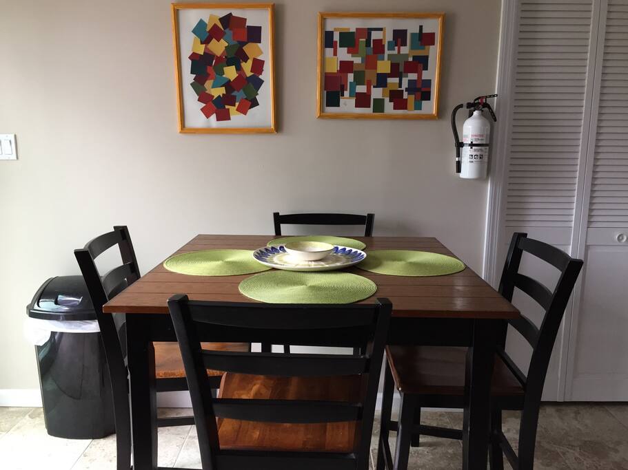 Tall dining table with additional seating on the counter bar stools