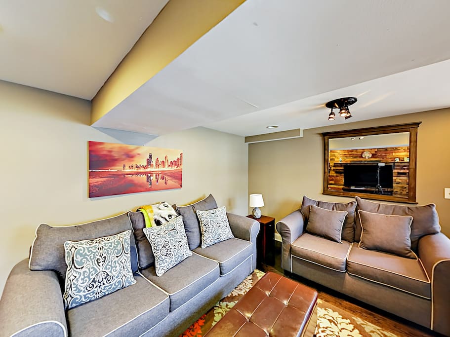 Sprawl out on 2 sofas and an armchair in the living room -- 1 of the sofas opens to reveal a queen-size sleeper.