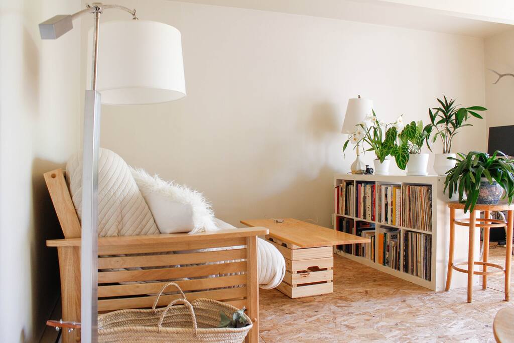 living room with a large collection of art books and records