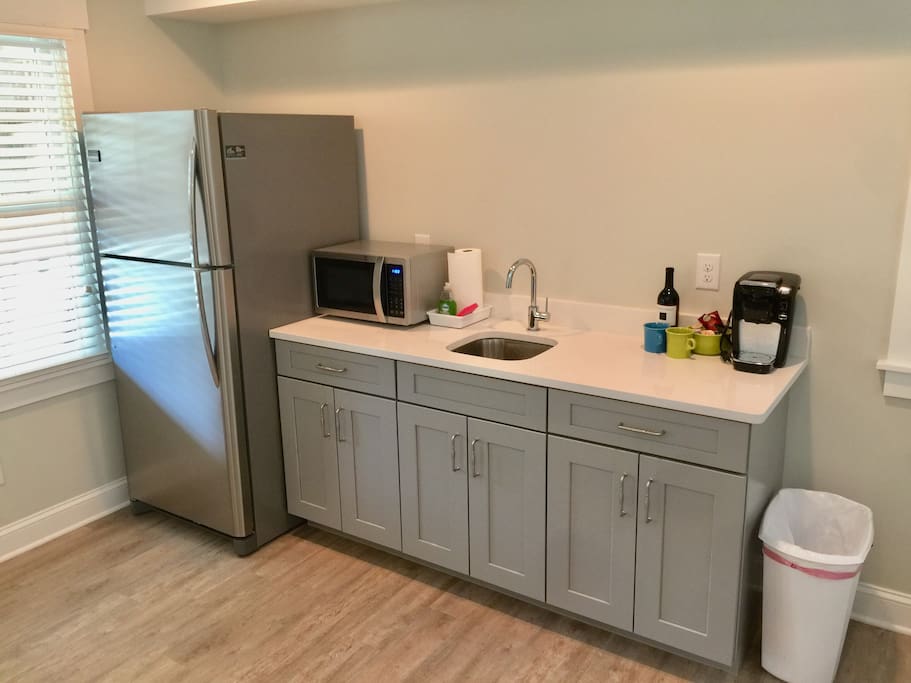 Kitchen area with full fridge
