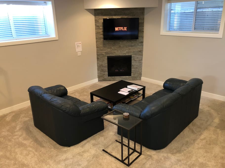 Relax in the living room area with fireplace and big screen TV
