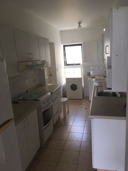 Full kitchen, machine washer and dryer.