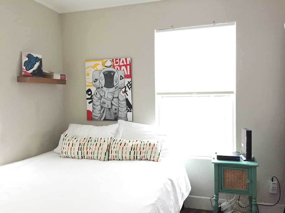 Second bedroom w/ Queen bed and a showcase of unique art