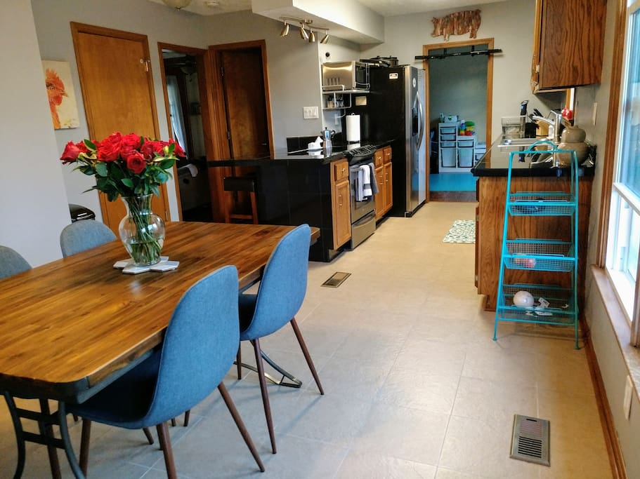 View of kitchen, dining space, and peninsula with two counter height seats