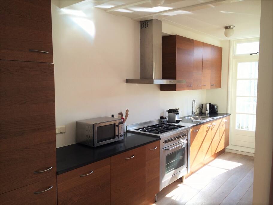 Modern kitchen with 5 burner gas stove and in-built fridge and dishwasher