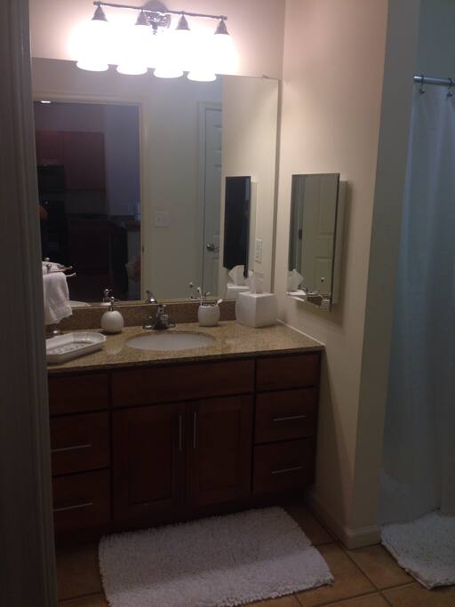 Clean bathroom with full tub and shower. Towels, toilet paper & some toiletries provided for guests.
