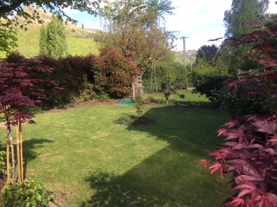 Front Garden. Which we don't mind if you need to pitch a tent to sleep more guests. Also has an awesome kids swing.