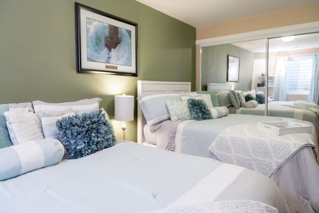 There are two full size beds in a bedroom that closes off with French doors for additional privacy. This area comfortably sleeps 4 guests.