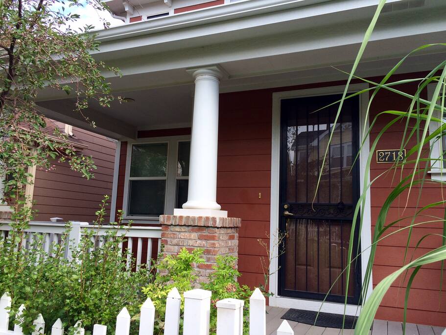 Welcoming front door with a porch and chairs for lounging.