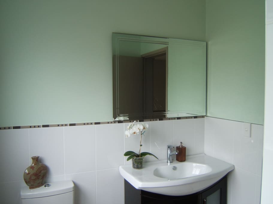 Clean fresh bathroom with shower and toilet