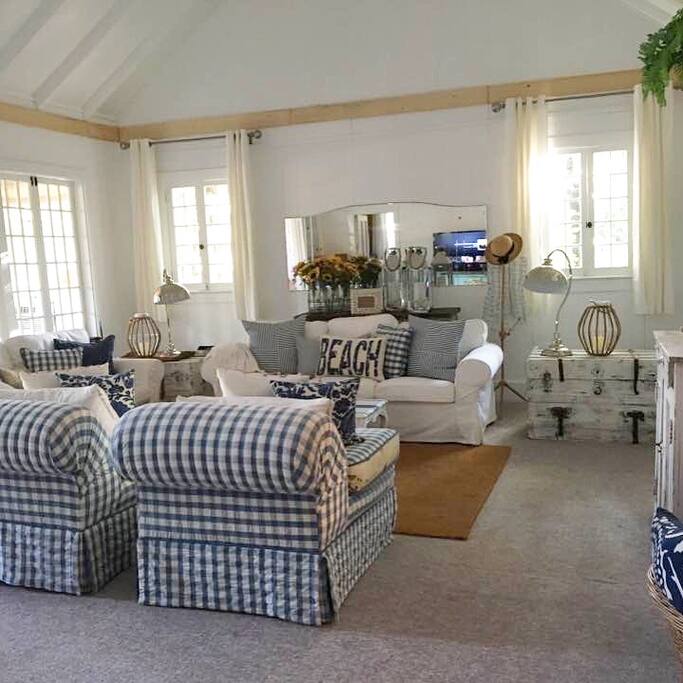The main living room has vaulted ceilings and shabby beach decor.