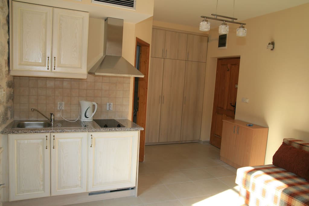 From window corner towards kitchenette, fitted wardrobe, front door to right, bathroom door centre