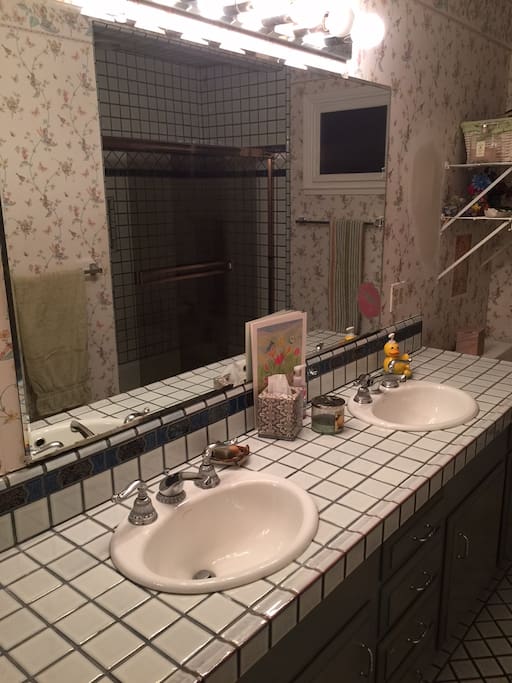 Your bathroom with shower and relaxing tub.