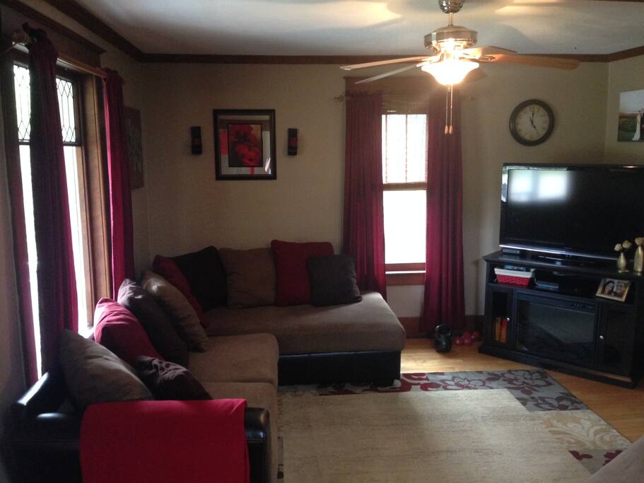 Main floor living room with sectional couch, love seat and ottoman.