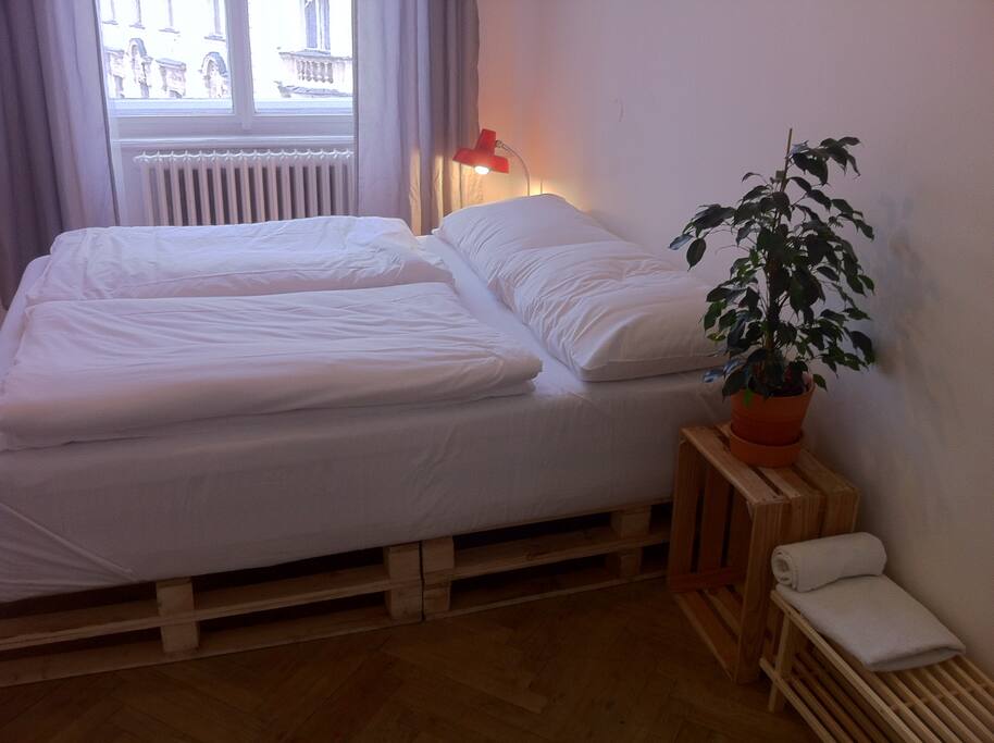 One queen-size bed and one double-size pallet bed (not pictured) in the room. Minimal design aesthetic, retro details.