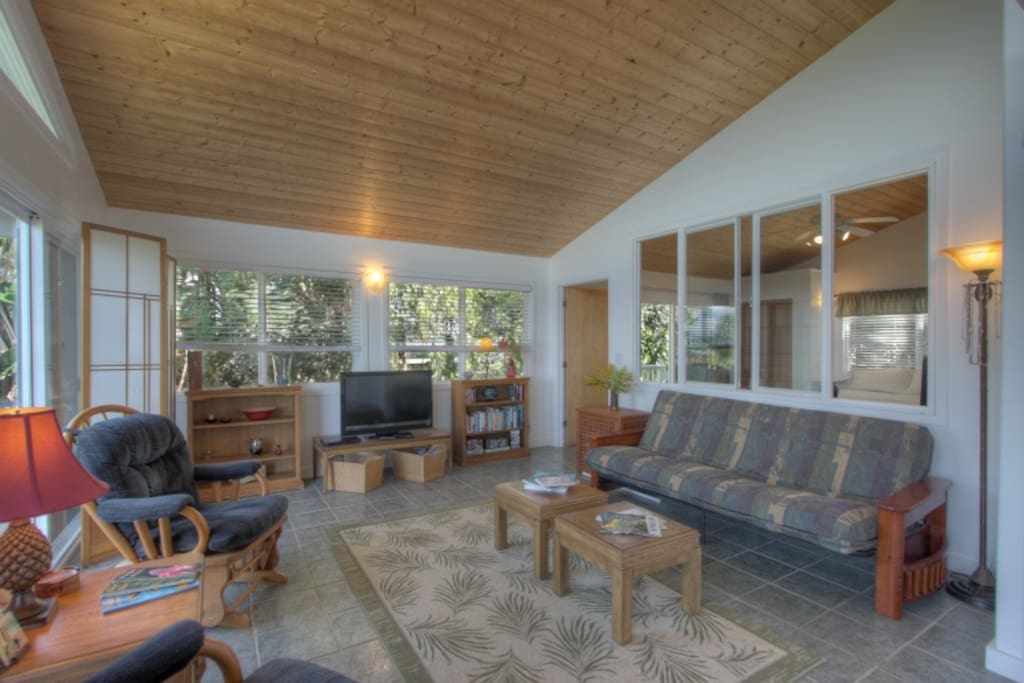 Our living room is open and welcoming! The window behind the couch allows guests in the master bedroom to see the ocean without rising.