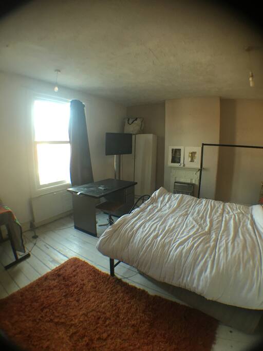 Front bedroom painted wooden floor with rugs