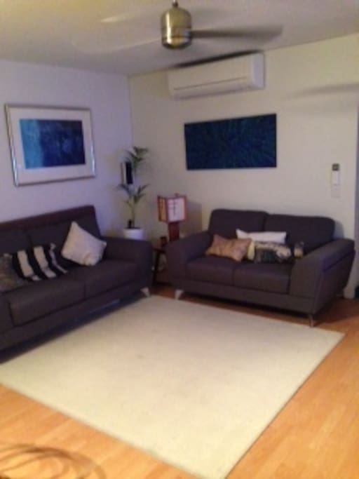 Comfy lounge room with ceiling fan and reverse cycle air con / heating