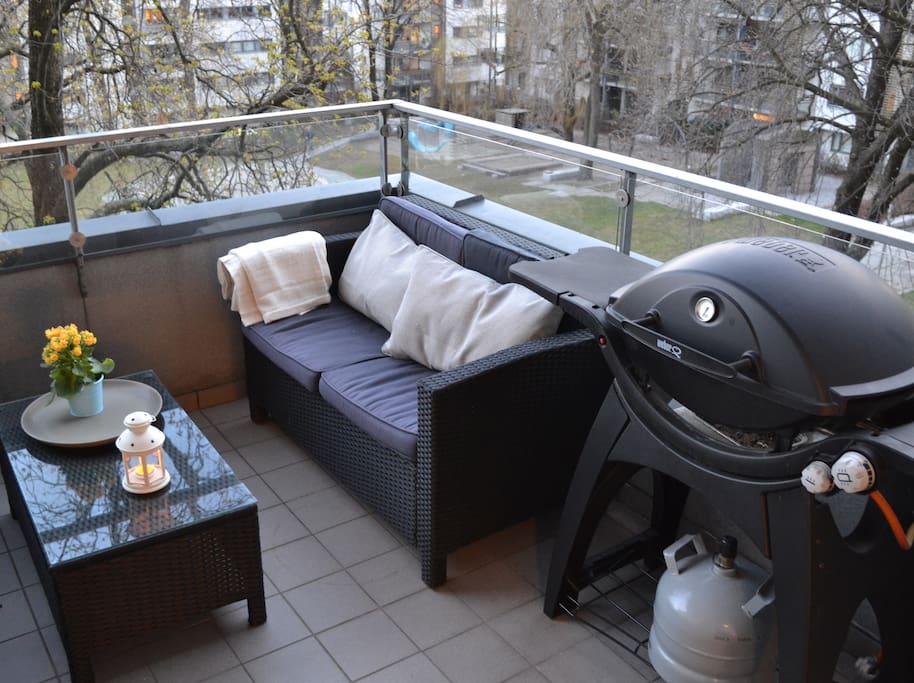 Large balcony with furniture and gas operated barbeque.