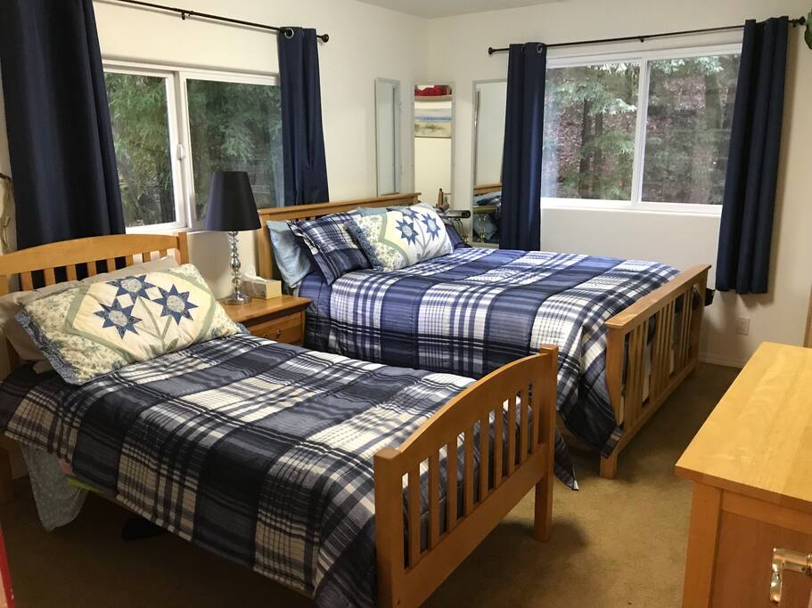 Room 2 - Large bedroom with comfy queen-size and twin beds. Electric heater and dressers.