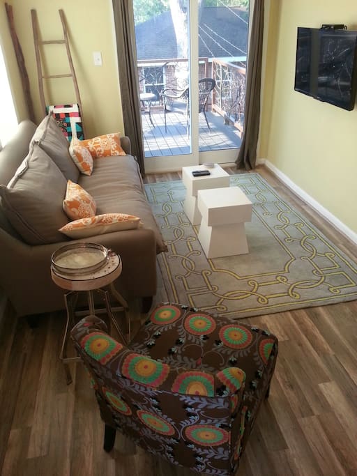The bright, comfortable living room leads to a great deck for relaxing outdoors.