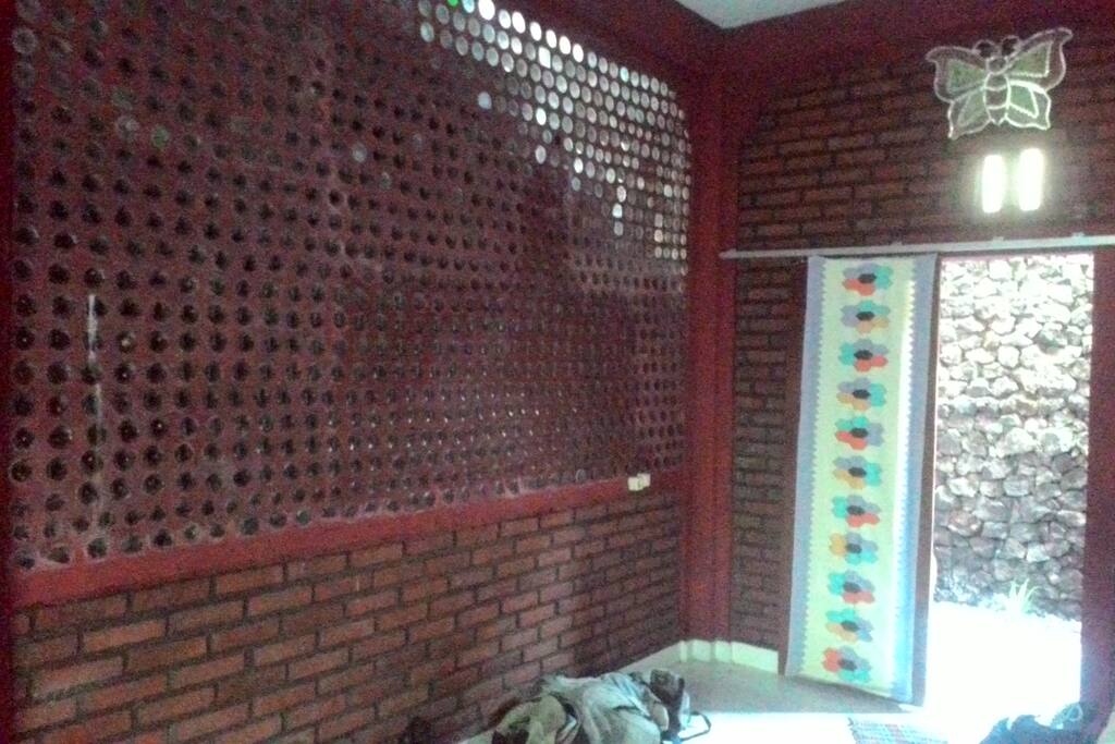 Wall built from recycle glass bottles to maximize natural light