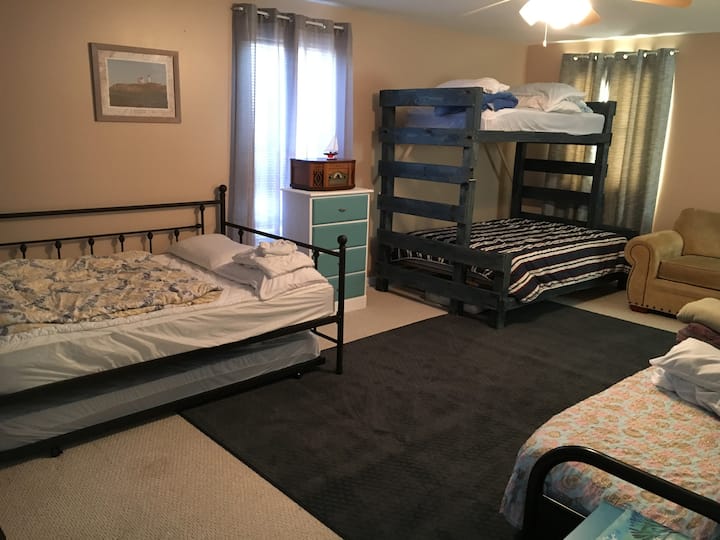 Upstairs second large bedroom. 2 full size beds, 1 full size futon, 2 twin beds (one is bunk bed and other is pull out trundle under the day bed), plus air mattress in the closet. 

Total of 8-10 sleeping spots.