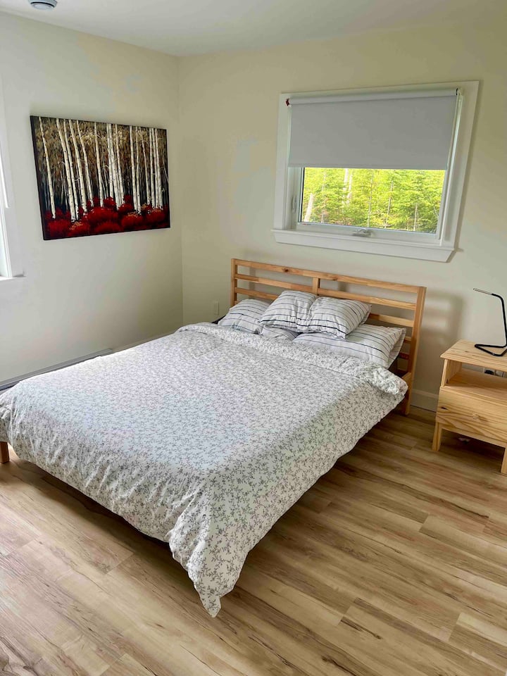 Dormitorio n.º1 en la planta baja con cama queen y armario.