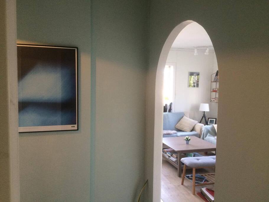 The hallway and living-room, photo taken from the kitchen.