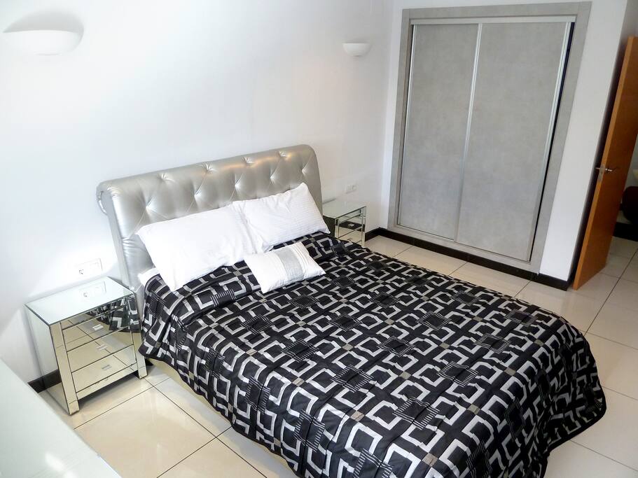 D2: DOWNSTAIRS BEDROOM 2. This bedroom features a large wardrobe and modern furniture.