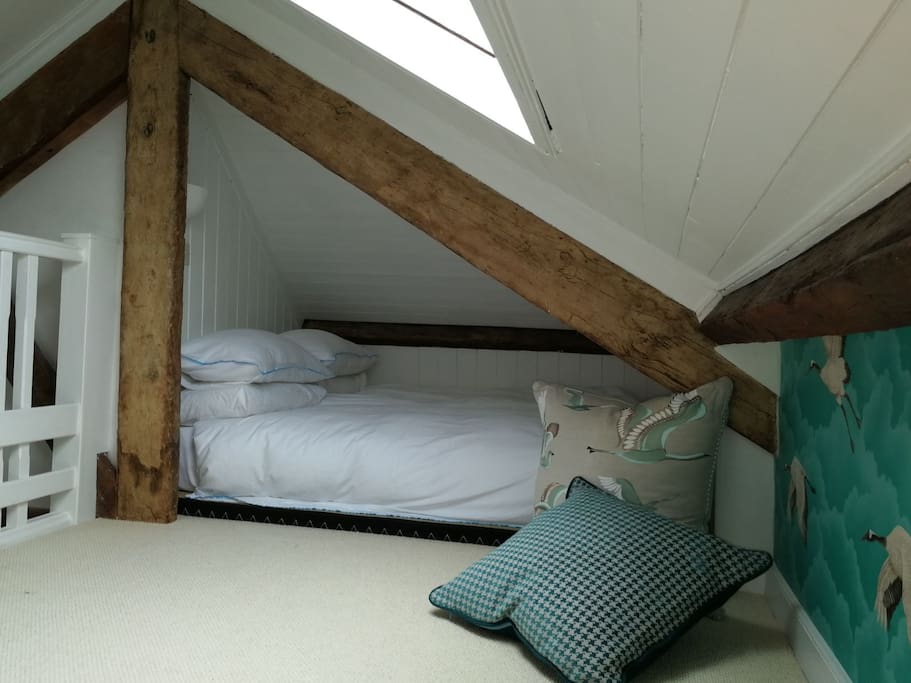 high quality memory foam mattress rests on woven Tatami mats in the mezzanine level. reading light in alcove and plenty of space to chill out and bask in the morning light or watch the clouds out of the Velux window