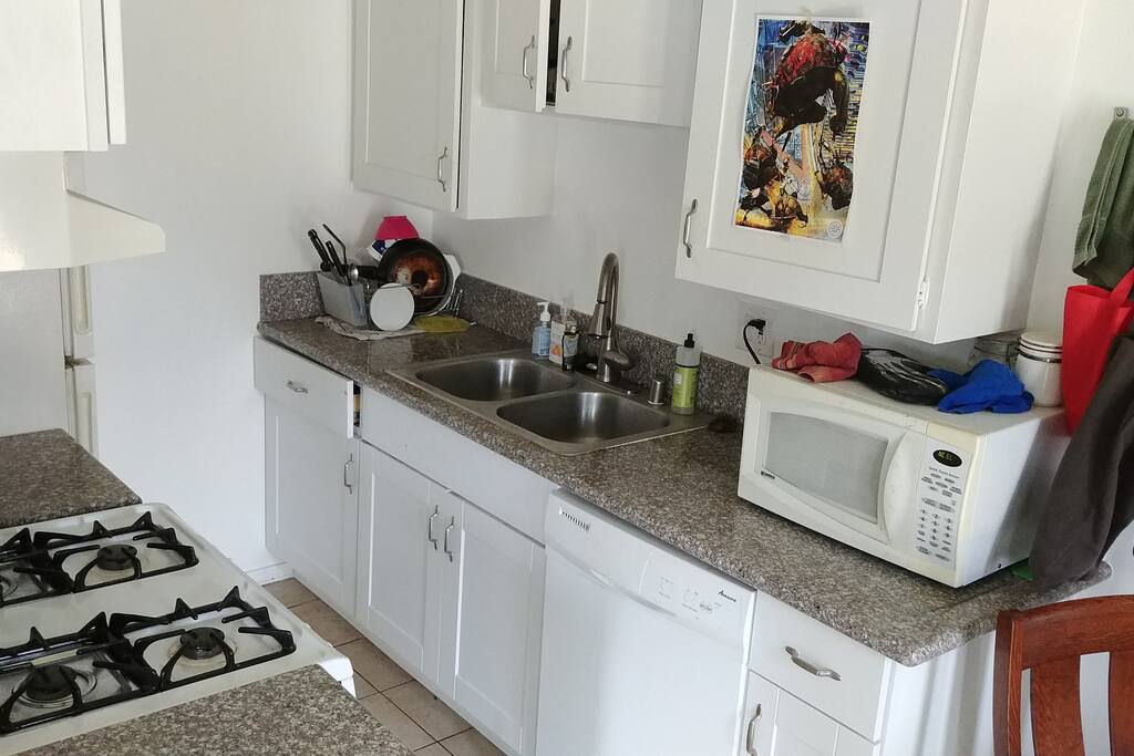 newly remodeled kitchen with granite countertops, gas range, refrigerator, and dish washer.