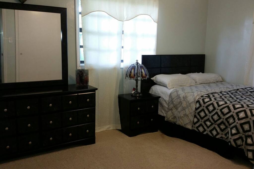 Very nice bedroom #2 with tv and view of the pool and backyard