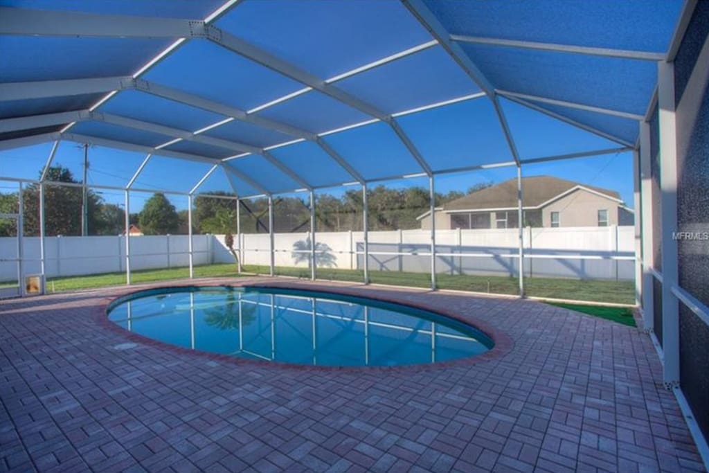 Relax out back on the screened in patio by the pool, or just jump in for a swim!