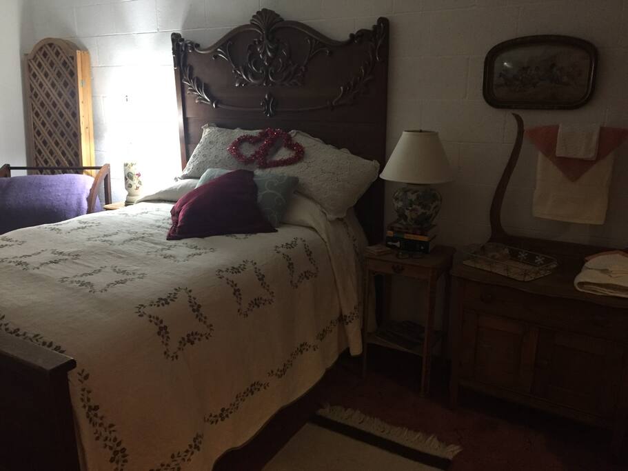 Cozy, comfy, antique bed with newer mattress.