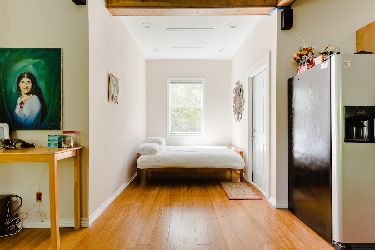Secluded tree house apartment with high ceilings.