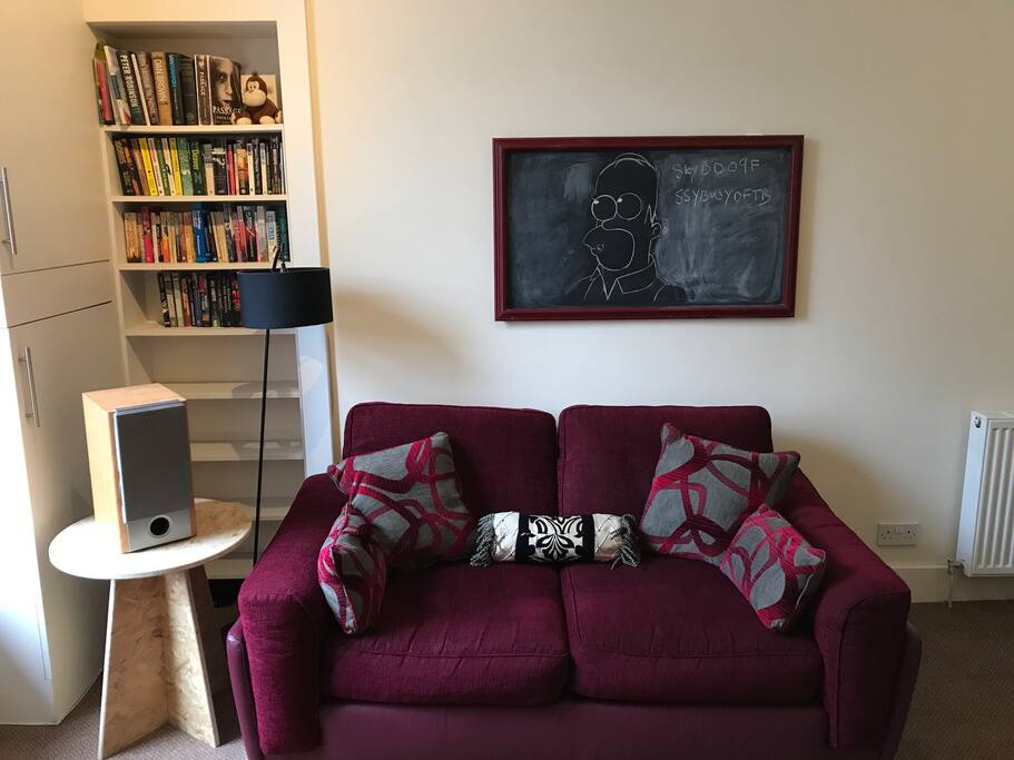 Lounge area with a selection of books and a bluetooth speaker