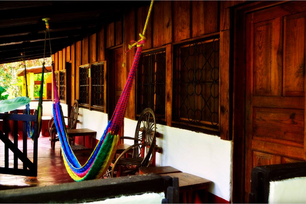 The room has a lovely porch with hammocks, a table and chairs overlooking the garden.
