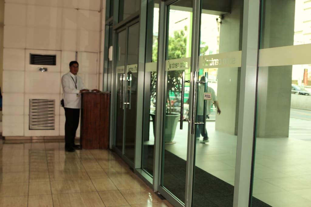 Inside the lobby with security personnel.
