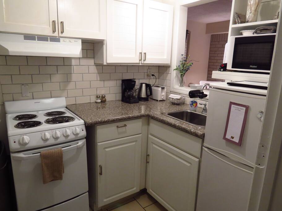 Fully equipped kitchen with all the essentials, including a coffee maker and coffee.