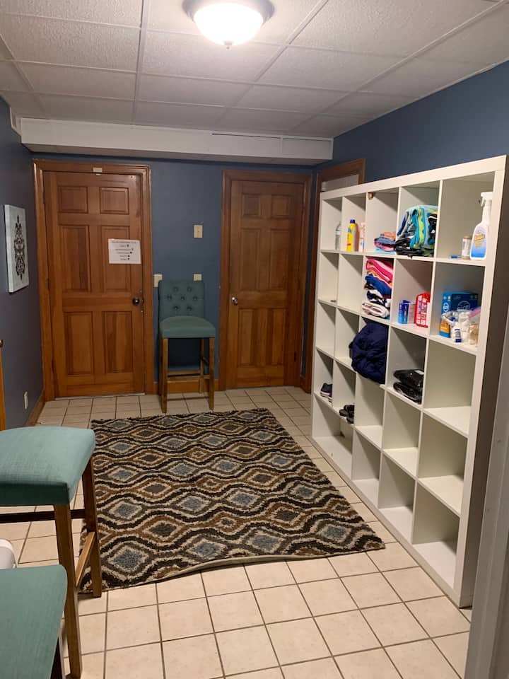 Entry way from basement deck.  In cubbies you will find pool towels, sunscreen and bug spray as well as a pool alarm if you would like to use it with small children.  First aid supplies can also be found here.