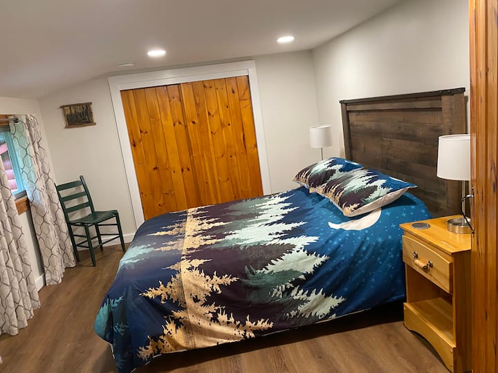The first bedroom with wooded views has a queen bed, a nicely sized closet and an upright dresser so you can make yourself right at home.
