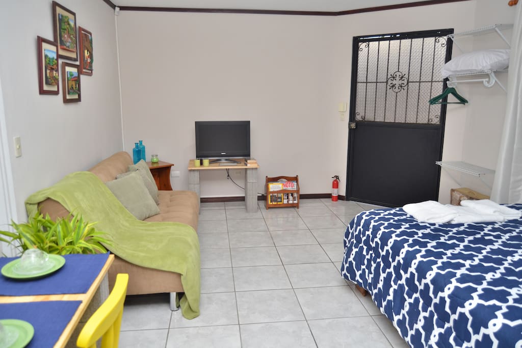 View from the back of the room. You can see the main entrance, books, TV, sofa bed, magazines & fire extinguisher.
Cable TV with 70+ Channels. We do offer Chromecast if you want to stream from your Smart Phone, Tablet or Laptop. Supports Netflix, YouTube, Popcorn Time & more