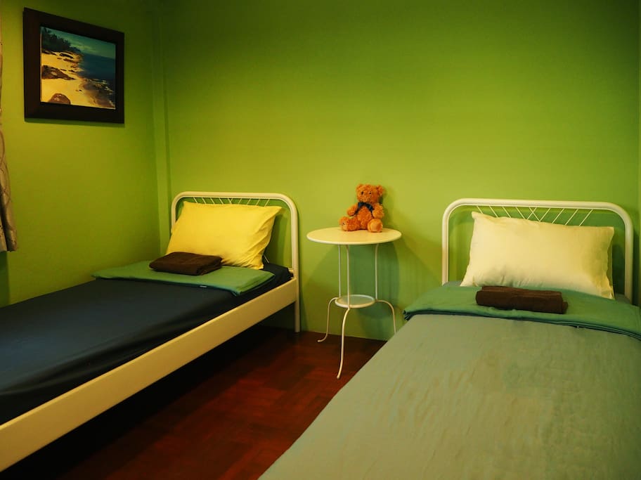 3 Single beds in the room with refreshing green theme that could make you feel more relax. This room is shared bathroom but no worries, its super clean.