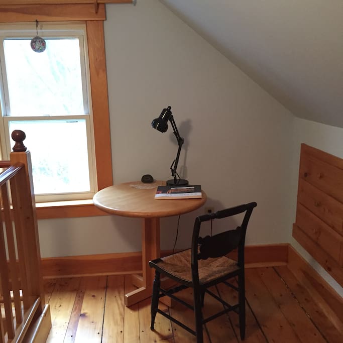 Bright writing desk overlooking river.