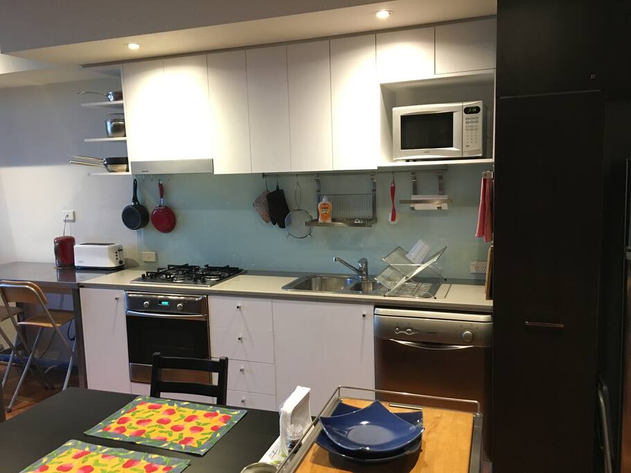 Contemporary kitchen with dishwasher and microwave.