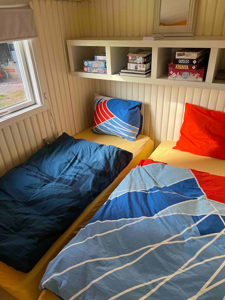 Bedroom in the main house with 2 single beds, and pillows and duvets for 2 people. You find here also board games and garden games for the entire family. Please remember to bring your own bed sheets and covers. 