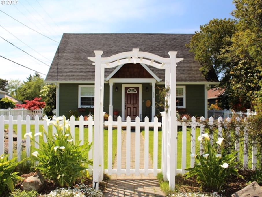 Gated front yard with mature perennial garden.